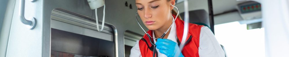 Young doctor with stetoscope listening patient heart and lungs.